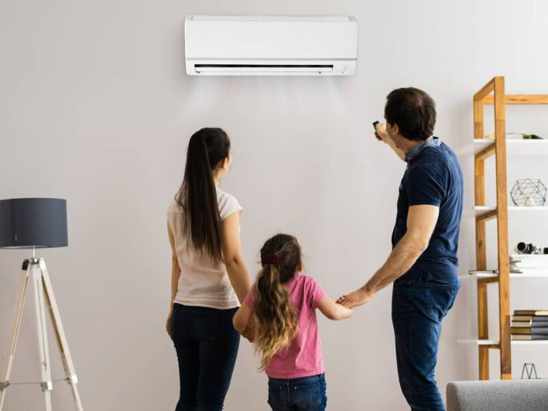 family adjusting a ductless heat pump