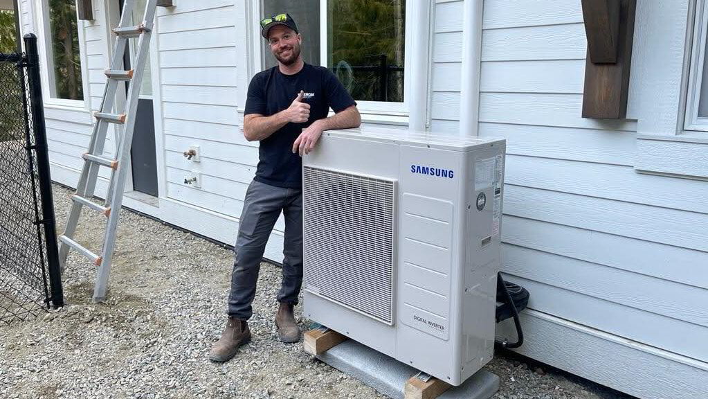 HVAC technician with a new heat pump