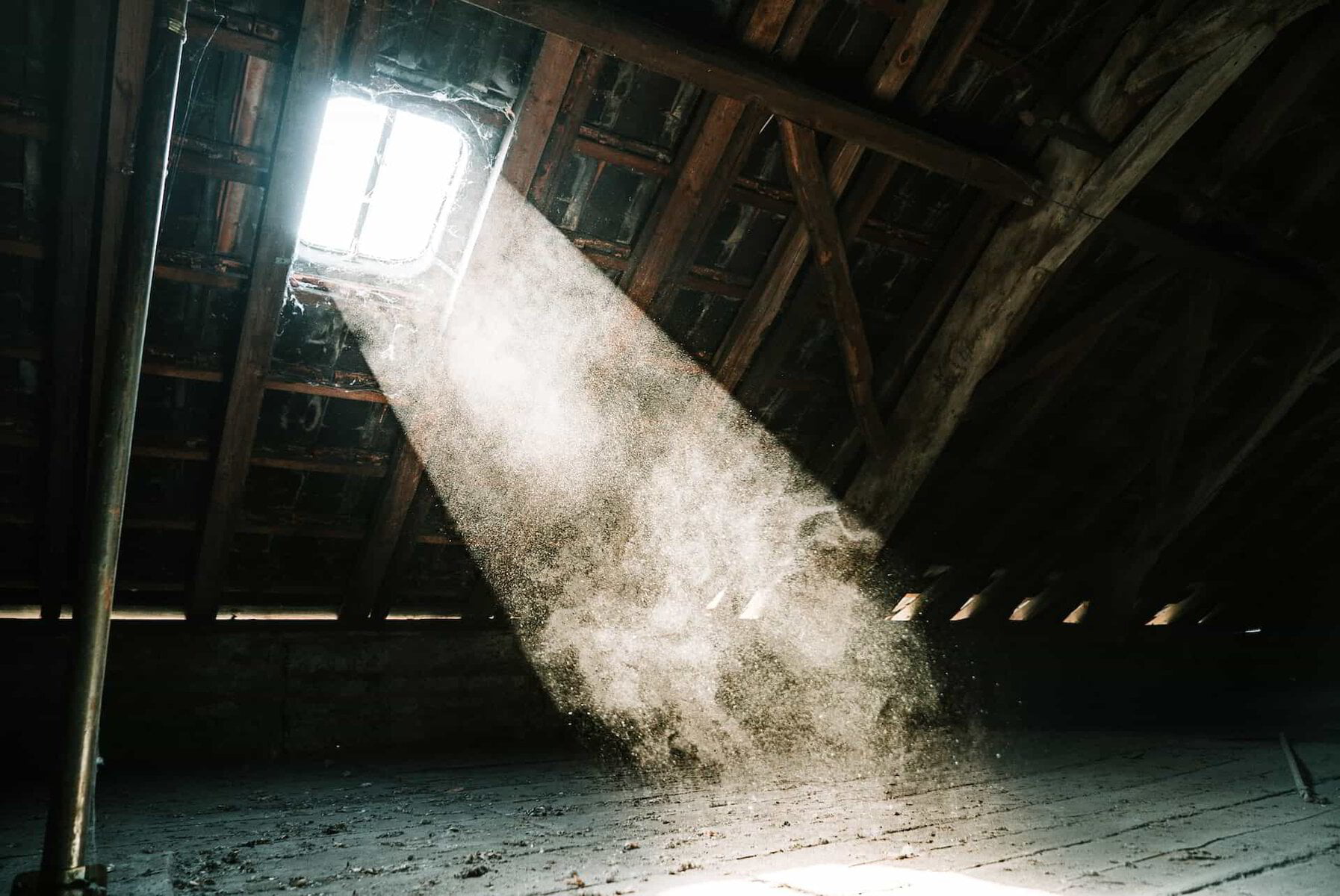 light shining through a window in a dusty home
