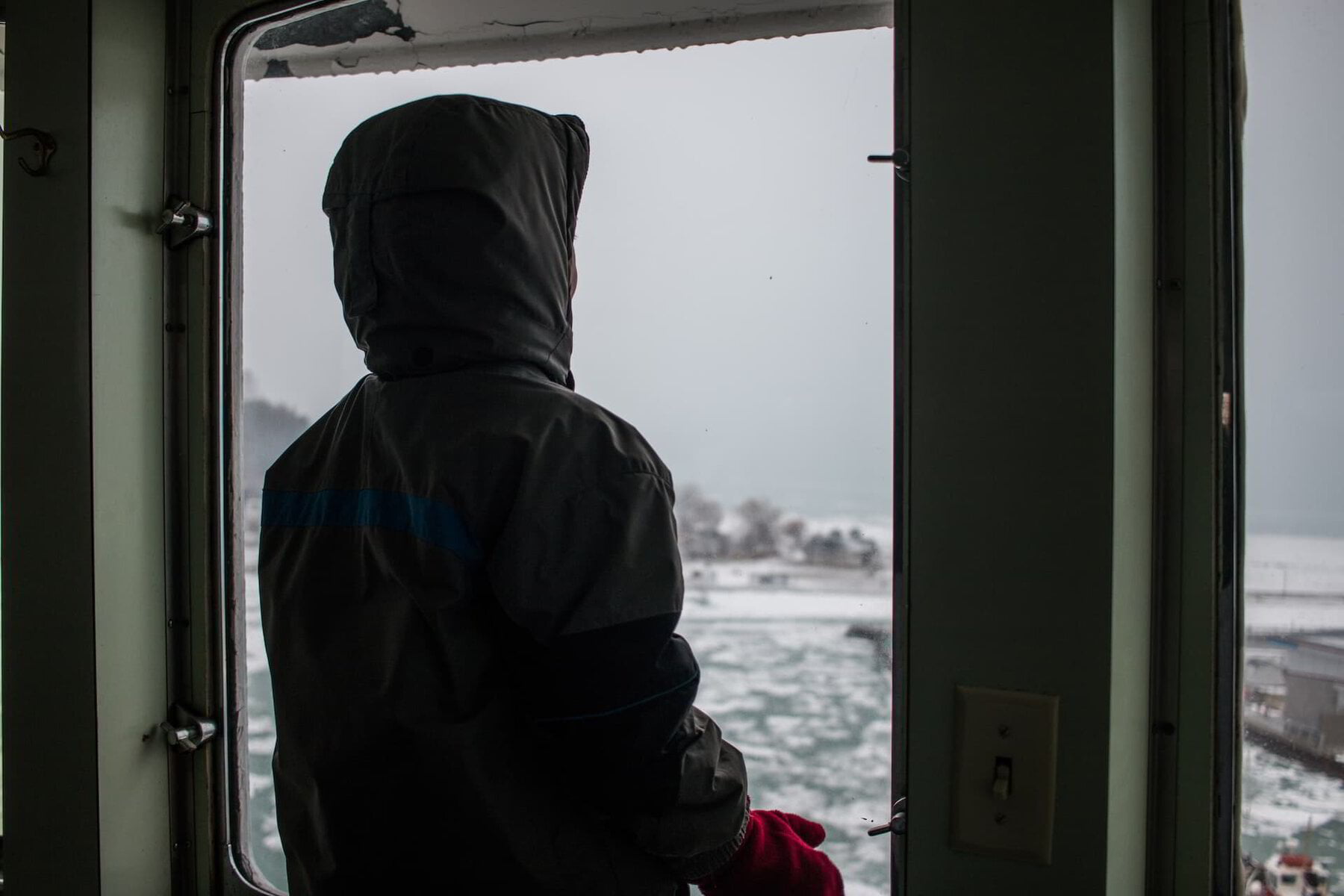 man standing inside a cold home