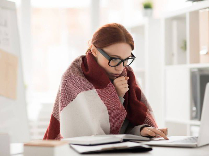 woman with blanket on a computer