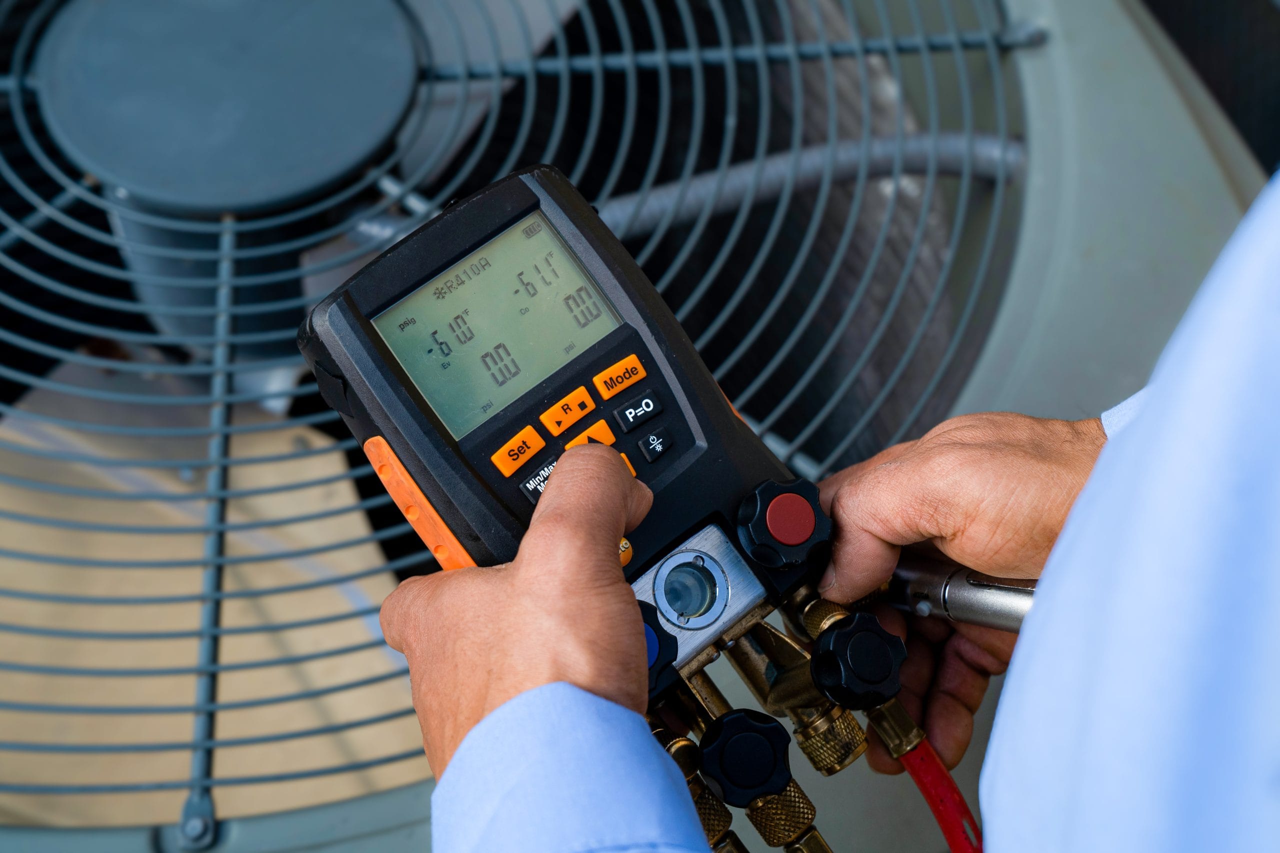 hvac technician performing ac system diagnostics